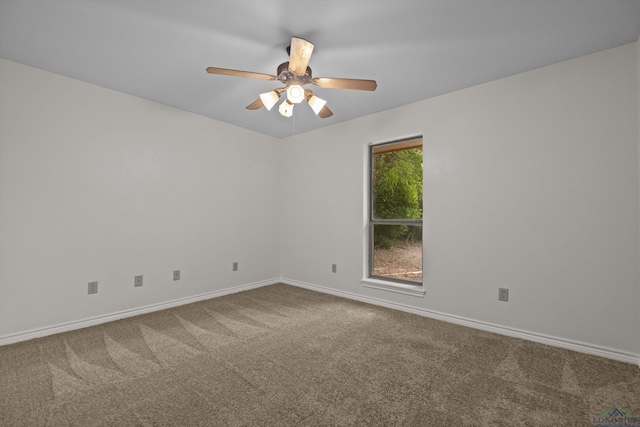 carpeted empty room featuring ceiling fan