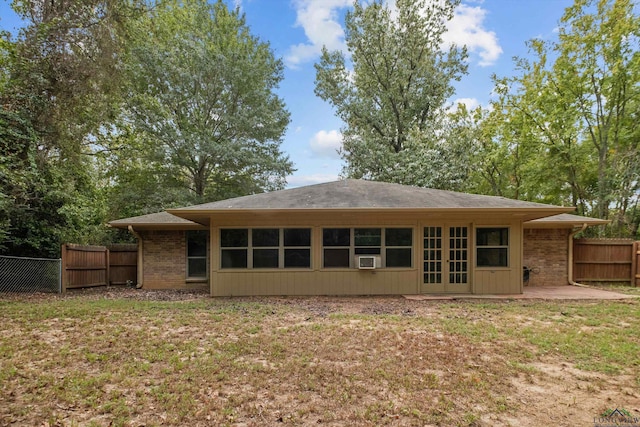 back of property with a patio, cooling unit, and a yard