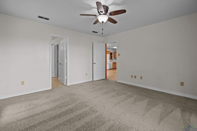 unfurnished bedroom with light colored carpet and ceiling fan