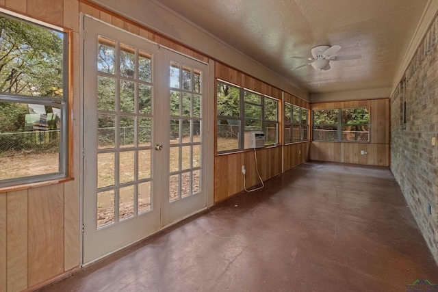 unfurnished sunroom with cooling unit and ceiling fan