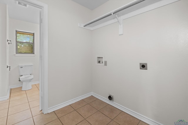 clothes washing area with light tile patterned floors, electric dryer hookup, and hookup for a washing machine