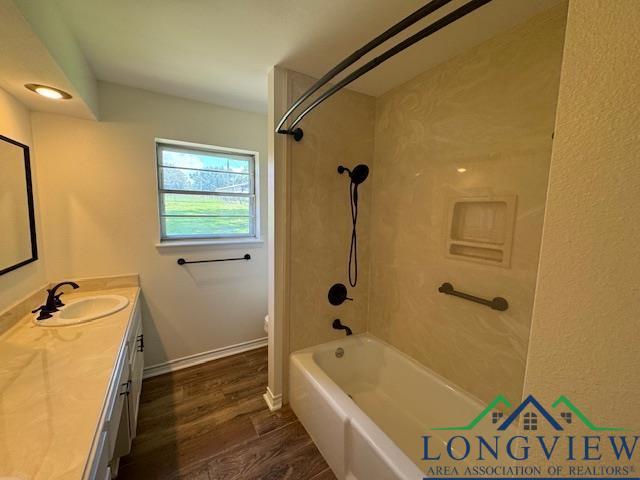 full bathroom featuring hardwood / wood-style floors, vanity, toilet, and bathing tub / shower combination