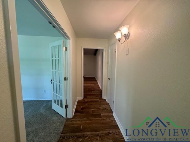 hallway with dark hardwood / wood-style floors