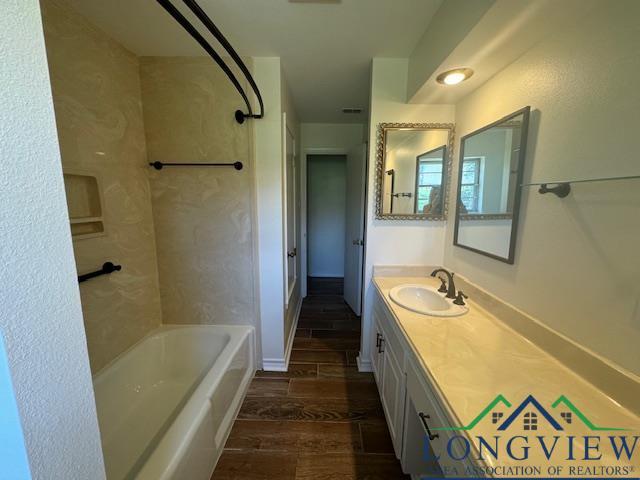 bathroom featuring shower / tub combination and vanity