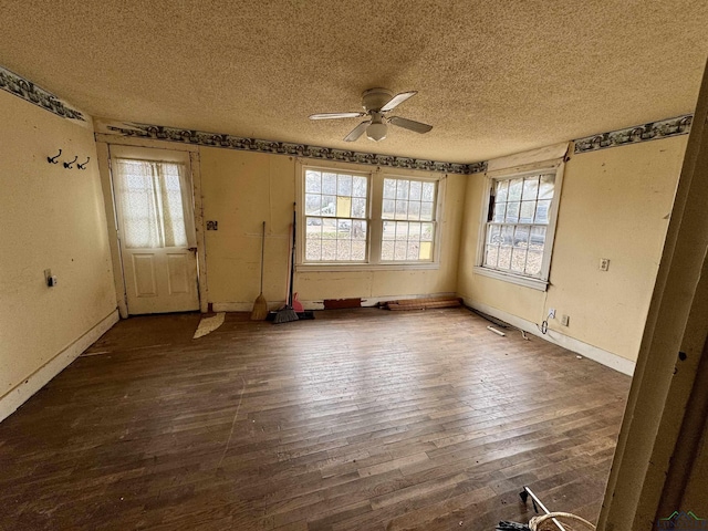 entryway with wood-type flooring, ceiling fan, a textured ceiling, and baseboards