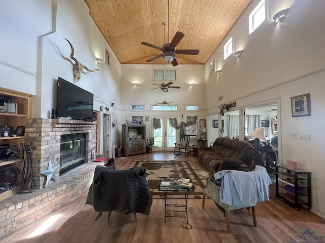 living room with french doors, wood ceiling, ceiling fan, and a high ceiling