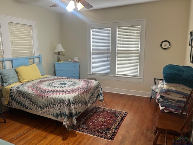 bedroom with dark hardwood / wood-style floors