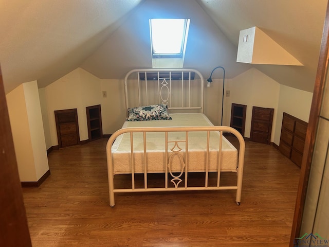 bedroom with dark hardwood / wood-style floors and vaulted ceiling