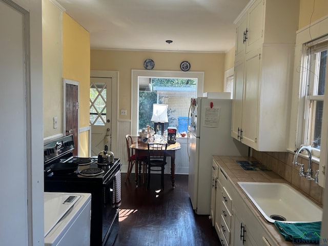 kitchen featuring white cabinetry, sink, tile counters, dark wood-type flooring, and black electric range