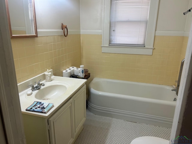 bathroom featuring a bath, vanity, tile walls, and toilet