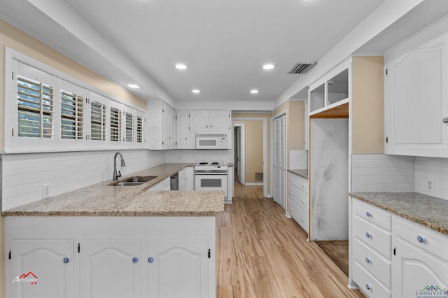 kitchen featuring white cabinets, white appliances, sink, and light hardwood / wood-style flooring