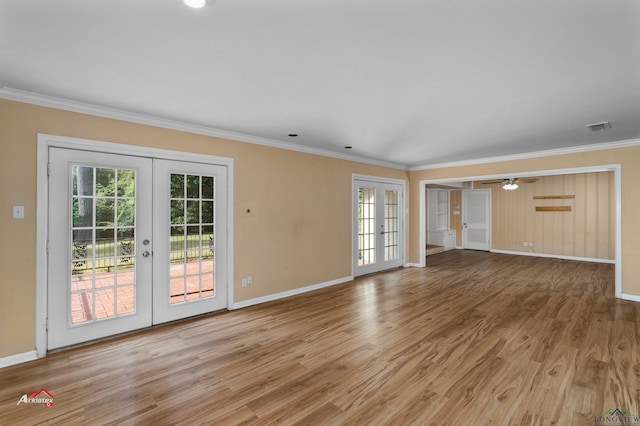 unfurnished living room with crown molding, french doors, ceiling fan, and light hardwood / wood-style flooring