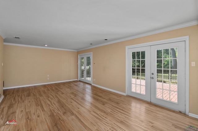 spare room featuring french doors, light hardwood / wood-style floors, and crown molding