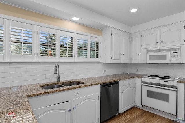 kitchen with white cabinets, white appliances, and sink