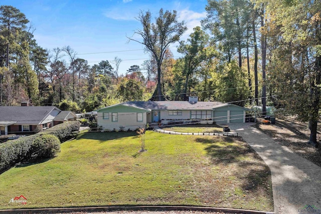 view of front of home with a front yard and a garage