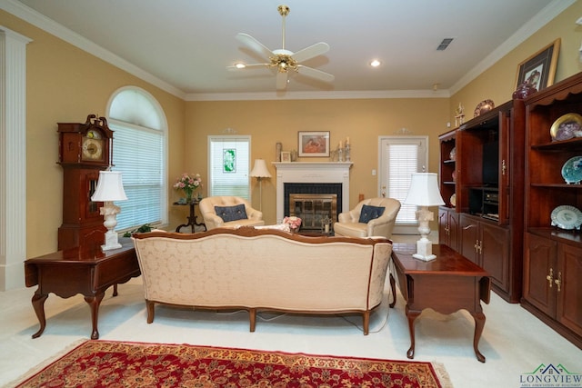 7 Casey Ct, Longview, TX 75604 - living area featuring light carpet, a glass covered fireplace, ceiling fan, and crown molding