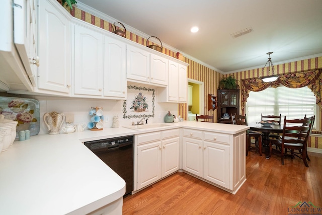 7 Casey Ct, Longview, TX 75604 - kitchen with black dishwasher, a peninsula, wallpapered walls, light wood-style flooring, and white cabinets