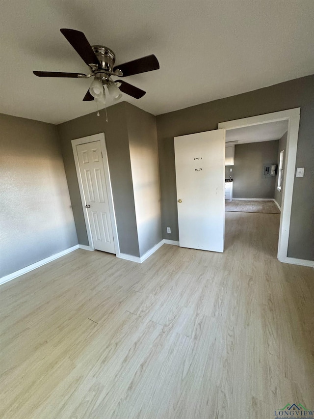 spare room featuring ceiling fan and light hardwood / wood-style flooring