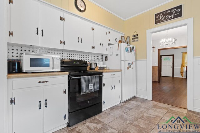 kitchen featuring light countertops, ornamental molding, white cabinetry, wainscoting, and white appliances