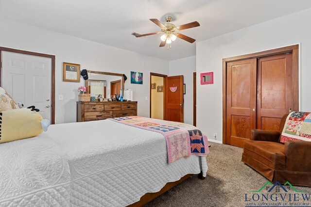 carpeted bedroom featuring baseboards and a ceiling fan