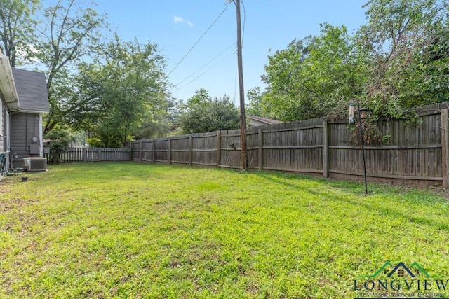 view of yard featuring a fenced backyard and central AC unit