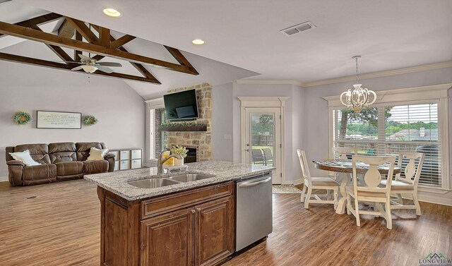475 Highland Pl, Hallsville, TX 75650 - kitchen with dishwasher, a stone fireplace, an inviting chandelier, a sink, and open floor plan