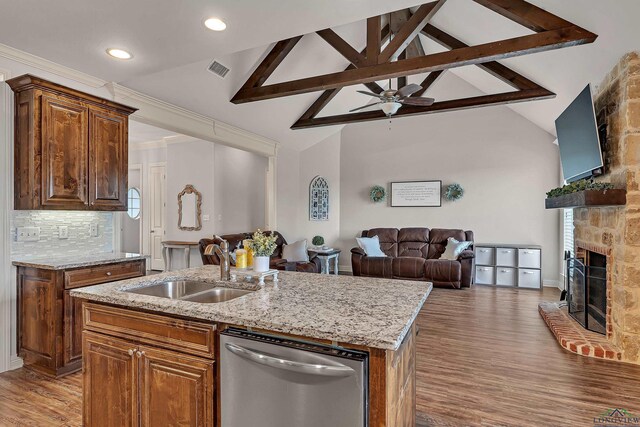 475 Highland Pl, Hallsville, TX 75650 - kitchen with a sink, dishwasher, light wood-style flooring, open floor plan, and light stone countertops