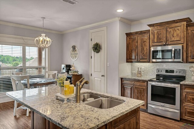 475 Highland Pl, Hallsville, TX 75650 - kitchen with a sink, tasteful backsplash, crown molding, dark wood-style floors, and appliances with stainless steel finishes