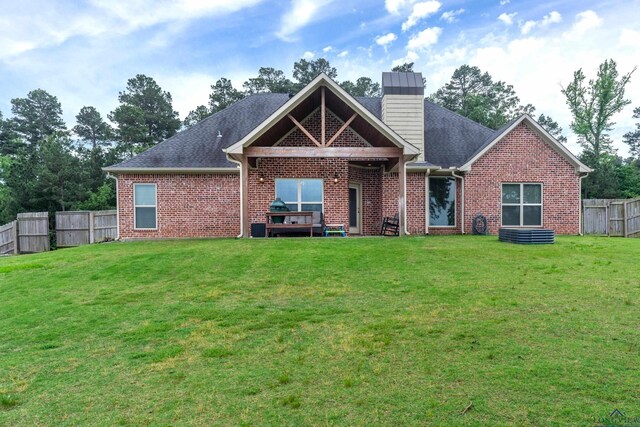 475 Highland Pl, Hallsville, TX 75650 - back of property featuring a yard, brick siding, a chimney, and a fenced backyard