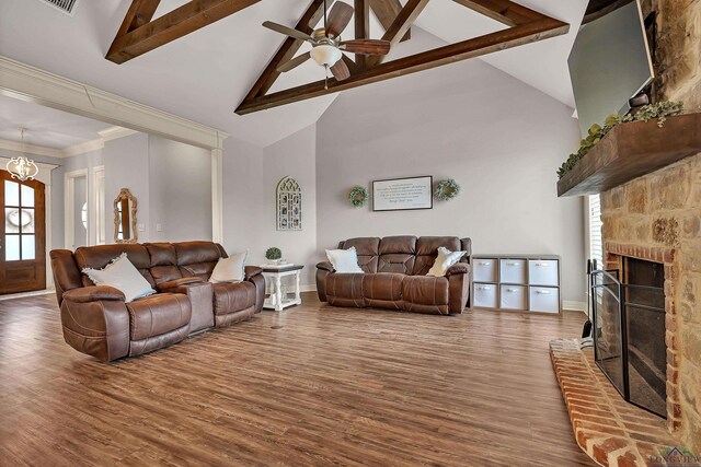475 Highland Pl, Hallsville, TX 75650 - living room featuring wood finished floors, ceiling fan with notable chandelier, high vaulted ceiling, a brick fireplace, and beamed ceiling