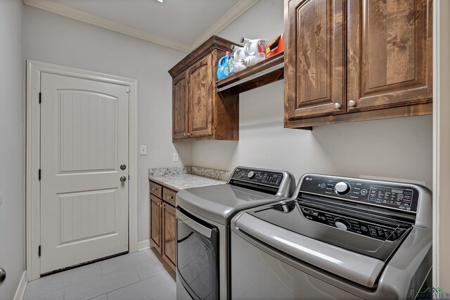 475 Highland Pl, Hallsville, TX 75650 - clothes washing area featuring cabinet space, washer and dryer, crown molding, light tile patterned floors, and baseboards