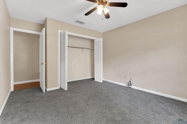 105 Bison Trl, Longview, TX 75601 - unfurnished bedroom with dark colored carpet, a closet, baseboards, and a ceiling fan