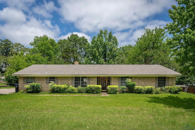 105 Bison Trl, Longview, TX 75601 - ranch-style home with brick siding, a front yard, and a chimney