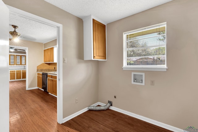 105 Bison Trl, Longview, TX 75601 - washroom with cabinet space, electric dryer hookup, a textured ceiling, wood finished floors, and hookup for a washing machine