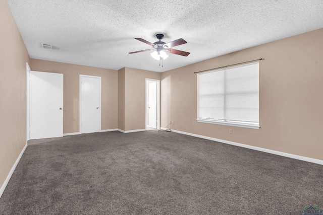 105 Bison Trl, Longview, TX 75601 - spare room featuring a ceiling fan, baseboards, dark carpet, and a textured ceiling