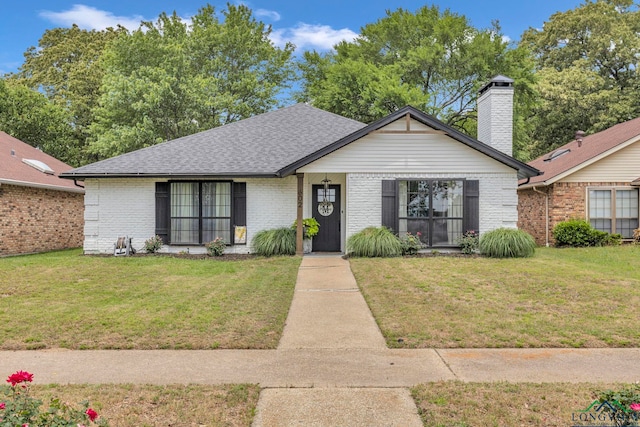 602 Pierce St, Lindale, TX 75771 - view of front facade featuring brick siding, a front yard, and a shingled roof