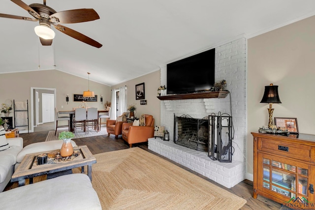 602 Pierce St, Lindale, TX 75771 - living area with ceiling fan, wood finished floors, a fireplace, lofted ceiling, and crown molding