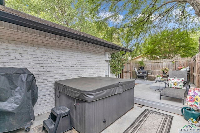 602 Pierce St, Lindale, TX 75771 - wooden terrace featuring a hot tub and a fenced backyard