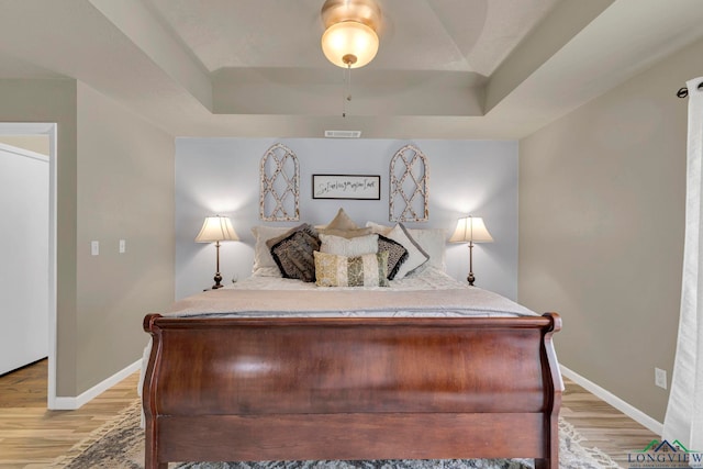 602 Pierce St, Lindale, TX 75771 - bedroom with a raised ceiling, light wood-type flooring, baseboards, and ceiling fan