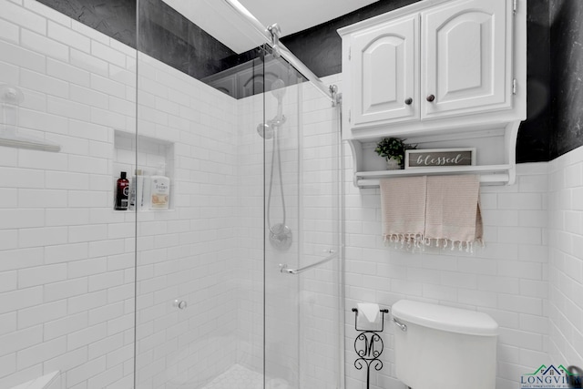 602 Pierce St, Lindale, TX 75771 - full bathroom with a shower stall, toilet, and tile walls
