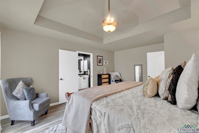 602 Pierce St, Lindale, TX 75771 - bedroom featuring a raised ceiling, baseboards, light wood finished floors, ensuite bath, and a ceiling fan