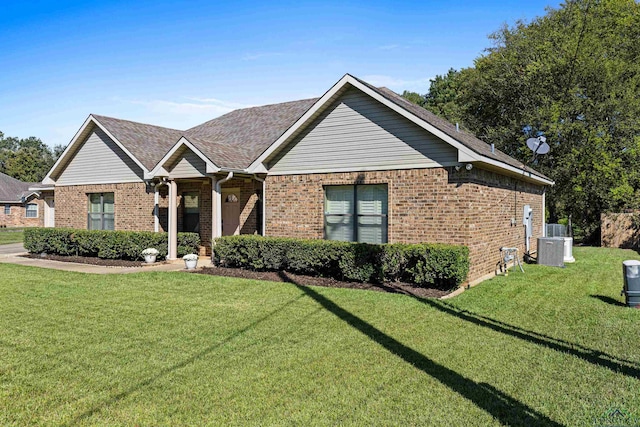 ranch-style house with central AC and a front lawn