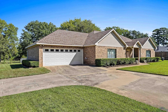 single story home featuring a garage and a front yard