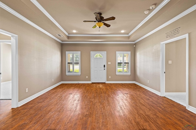 interior space featuring a tray ceiling, ceiling fan, crown molding, and hardwood / wood-style floors