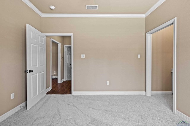 unfurnished bedroom with carpet floors and crown molding