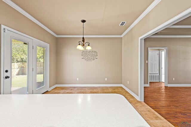 unfurnished dining area featuring a notable chandelier, light tile patterned floors, and ornamental molding