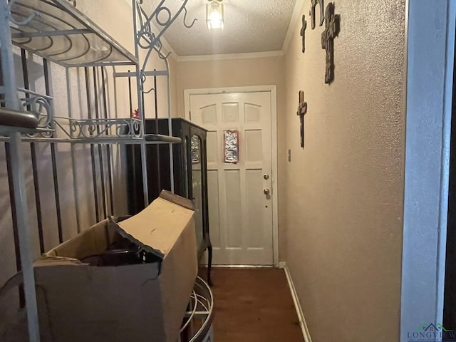 doorway featuring crown molding and a textured ceiling