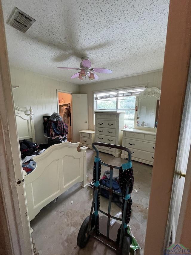 bedroom featuring ceiling fan, a spacious closet, and a closet