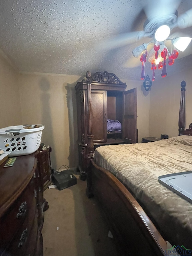 bedroom featuring carpet flooring and a textured ceiling