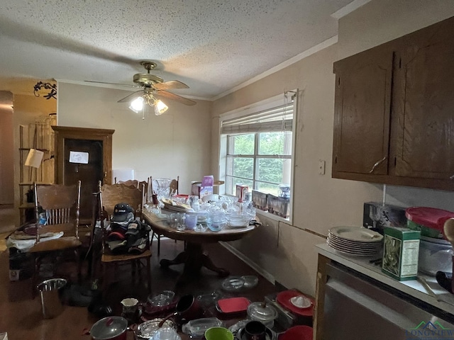 dining room with ceiling fan, ornamental molding, and a textured ceiling